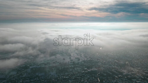 Video - Hyperlapse of Chisinau from drone above the fast moving clouds with buildings visible through, Moldova