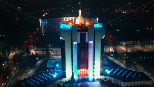 Video - CHISINAU, MOLDOVA - DECEMBER 20: 2020 Aerial drone hyperlapse timelapse of Presidency building and Parliament at night. Glowing lights