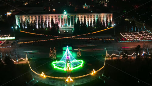 Video - Aerial drone hyperlapse timelapse of Government Building and Triumphal Arch at night. Christmas decorations