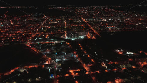Video - Hyperlapse of Chisinau at night, drone view. Multiple buildings, roads with moving cars, night city illumination. Moldova