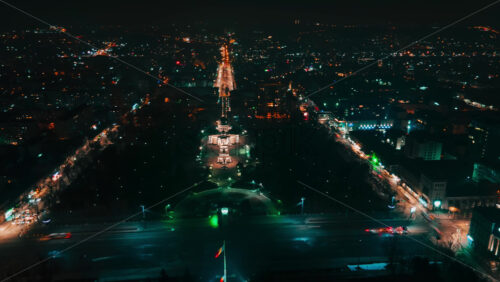 Video - Hyperlapse of Chisinau center at night, drone view. Cathedral, central park, buildings, roads with moving cars, night city illumination. Moldova