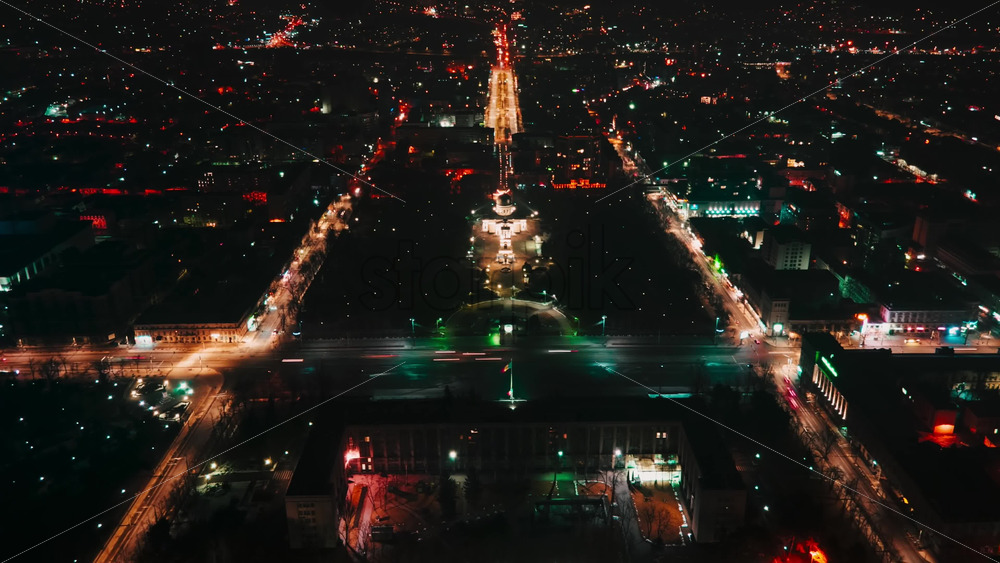 Video - Hyperlapse of Chisinau center at night, drone view. Cathedral, central park, buildings, roads with moving cars, night city illumination. Moldova