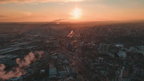Video - Hyperlapse of Chisinau at sunrise, drone view. Multiple buildings, roads with moving cars, smoke getting off the tubes. Moldova