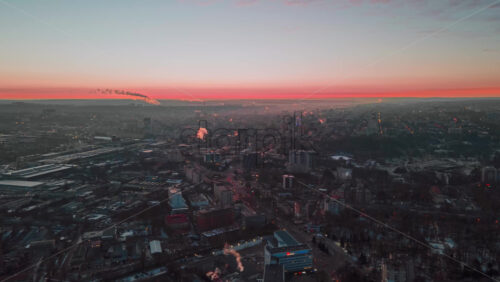 Video - Hyperlapse of Chisinau at sunset, drone view. Multiple buildings, roads with moving cars, smoke getting off the tubes. Moldova