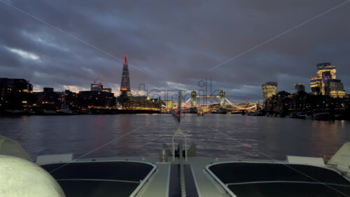 Video - The flag of the United Kingdom waving on a boat moving on the Thames River in the evening in London, England