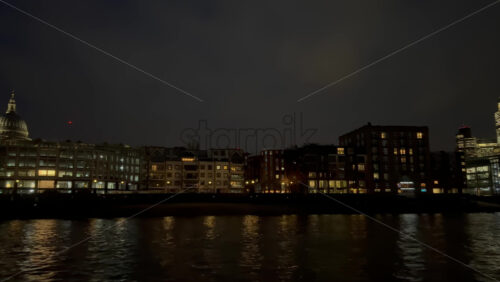 Video - View from a moving boat of the buildings alongside the Thames River in the evening in London, England