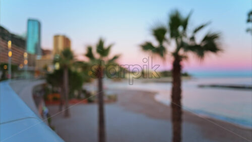 Video - Blurred biew of the Larvotto Beach in Monaco at sunset with the skyline of the city on the background