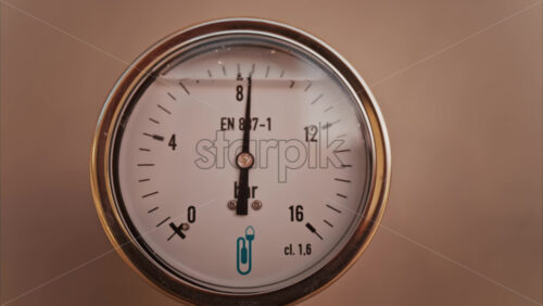 Video - Close up of a circular pressure gauge with a metallic frame indicating the current pressure is 8 bar