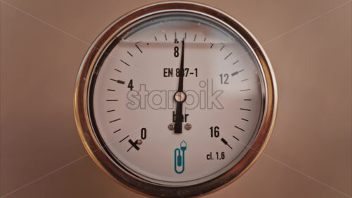 Video - Close up of a circular pressure gauge with a metallic frame indicating the current pressure is 8 bar