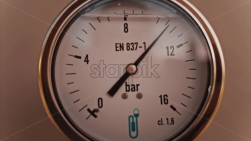 Video - Close up of a circular pressure gauge with a metallic frame indicating the current pressure is 8 bar