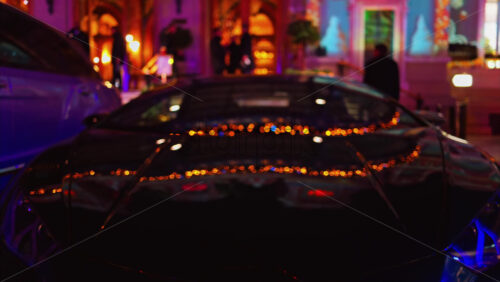 Video - Blurred view of a car parked in the courtyard of the Monte Carlo Casino in the evening in Monaco