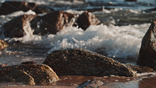 Video - Close up of waves hitting the rocks on the beach in Cannes, France