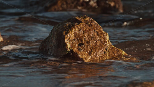 Video - Close up of waves hitting the rocks on the beach in Cannes, France