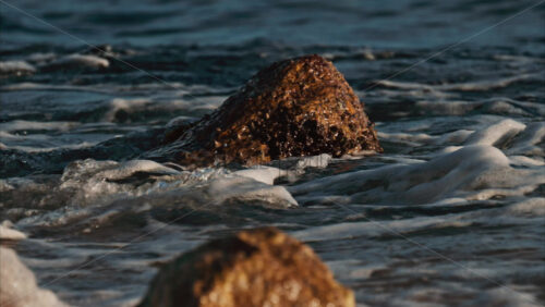 Video - Close up of waves hitting the rocks on the beach in Cannes, France