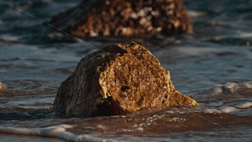 Video - Close up of waves hitting the rocks on the beach in Cannes, France