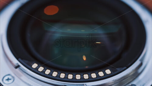 Video - Close up of a camera lens on a wooden table