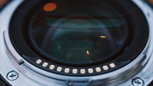 Video - Close up of a camera lens on a wooden table