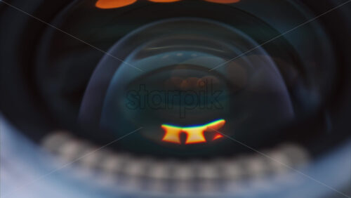 Video - Close up of a camera lens on a wooden table