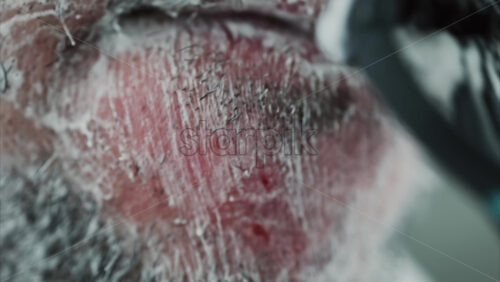 Video - Close up of a man shaving his beard with a razor