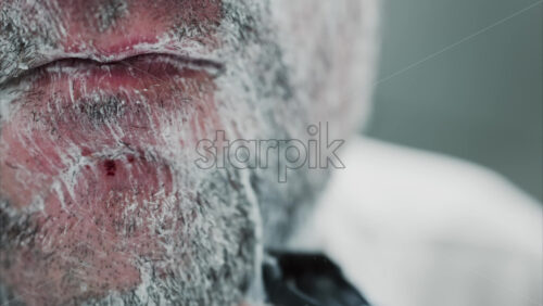 Video - Close up of a man shaving his beard with a razor