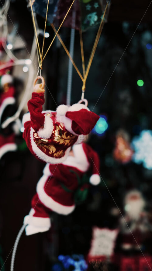 Video - Santa Claus toy rotating back and forth with a blurry background. Vertical