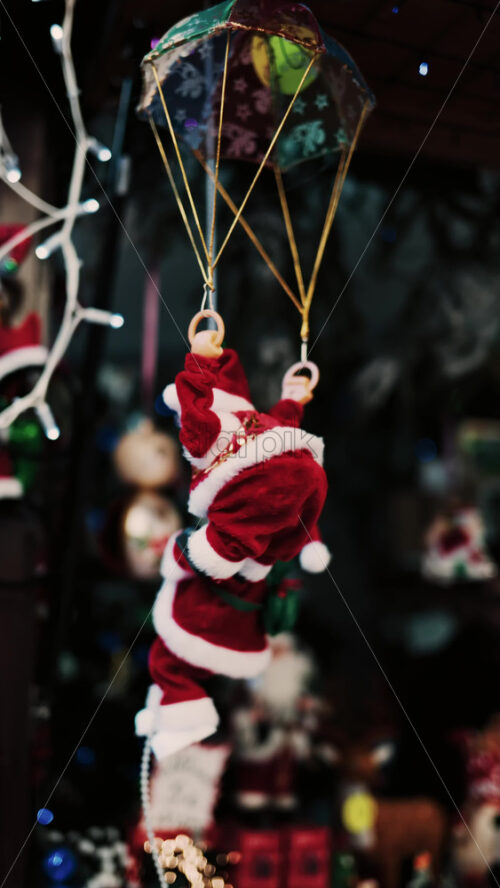 Video - Santa Claus toy rotating back and forth with a blurry background. Vertical