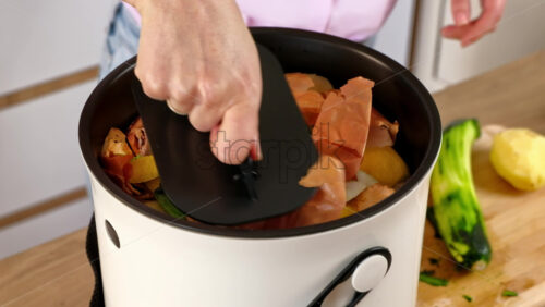 Video - Woman recycling organic waste by composting vegetables peels in the Bokashi in the kitchen
