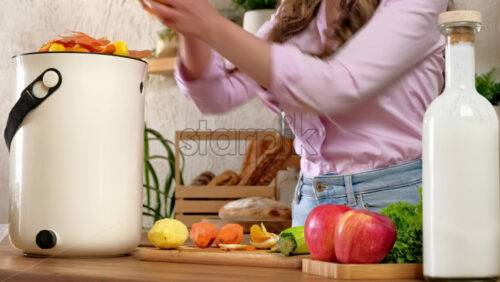 Video - Woman peeling vegetables and recycling organic waste by composting in the Bokashi in the kitchen