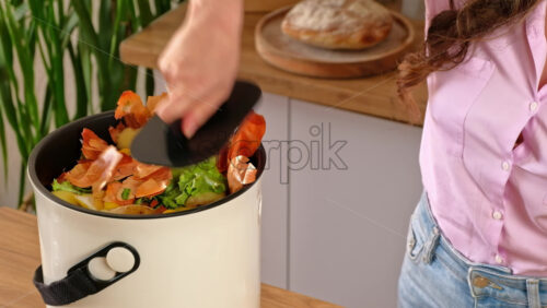 Video - Woman recycling organic waste by composting vegetables peels in the Bokashi in the kitchen