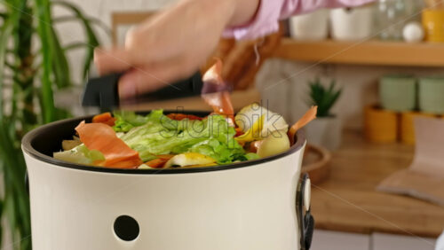 Video - Woman recycling organic waste by composting vegetables peels in the Bokashi in the kitchen