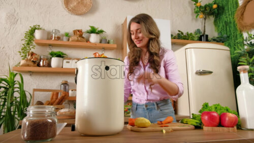 Video - Woman recycling organic waste by composting vegetables peels in the Bokashi in the kitchen