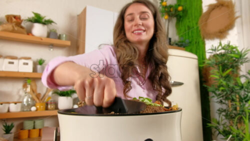 Video - Woman recycling organic waste by composting vegetables peels in the Bokashi in the kitchen
