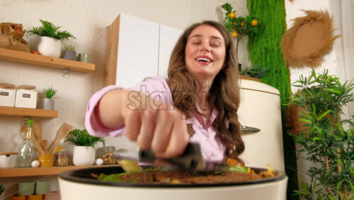 Video - Woman recycling organic waste by composting vegetables peels in the Bokashi in the kitchen