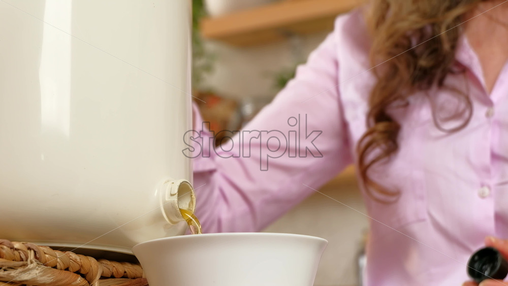 Video - Woman recycling organic waste by draining Bokashi liquid in the kitchen