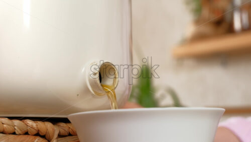 Video - Woman recycling organic waste by draining Bokashi liquid in the kitchen