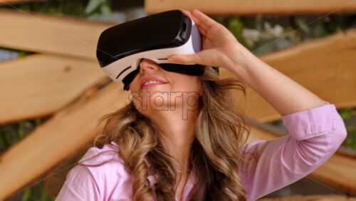 Video - Woman putting on VR headset and enjoying it