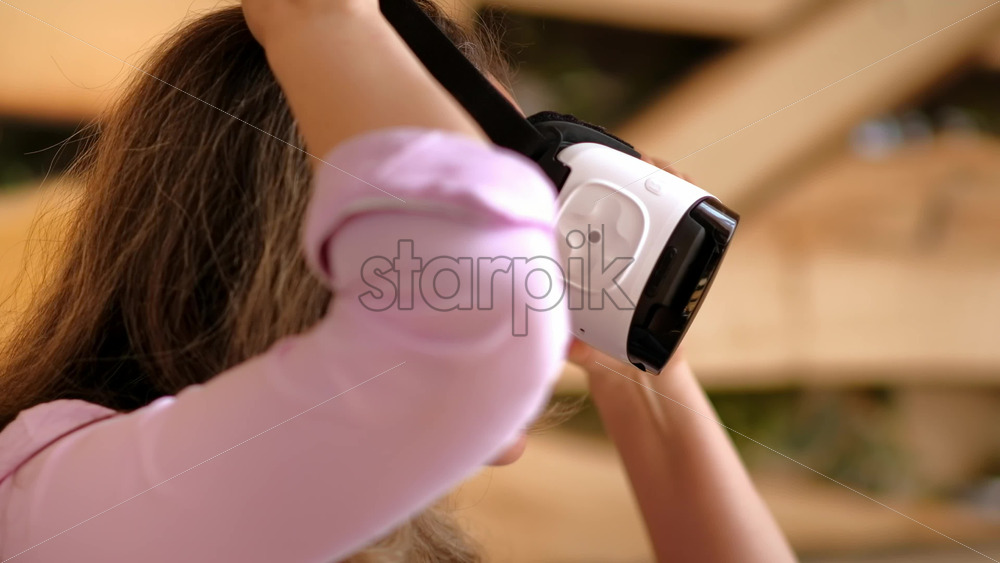 Video - Woman putting on VR headset and enjoying it