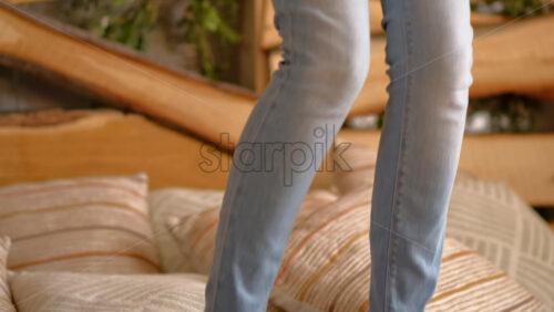 Video - Woman jumping on the bed while wearing VR headset