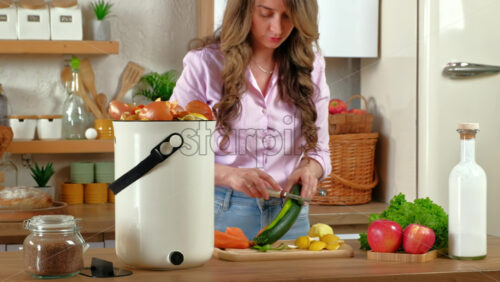 Video - Woman peeling vegetables and recycling organic waste in the kitchen