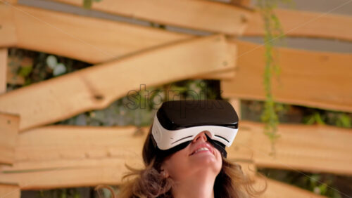 Video - Woman looking through VR headset and jumping on bed