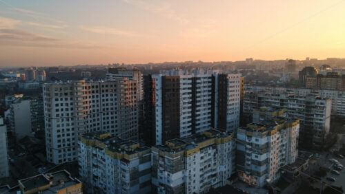 Video - CHISINAU, MOLDOVA - JANUARY 17, 2021: Aerial drone view of city at sunset. Multiple residential buildings. Winter