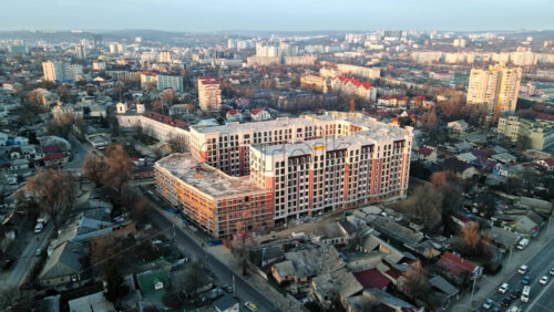 Video - CHISINAU, MOLDOVA - JANUARY 17, 2021: Aerial drone view of city at sunset. Multiple residential buildings. Bare trees, winter