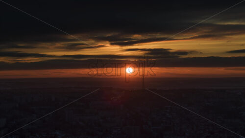 Video - Aerial drone hyperlapse timelapse of moving sunset sky with clouds. Red sun in Chisinau, Moldova