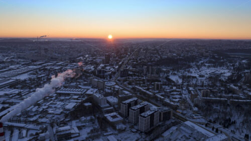 Video - Aerial drone hyperlapse timelapse of Chisinau city covered in snow at sunrise. Winter in Moldova