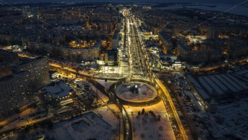 Video - Aerial drone hyperlapse timelapse of Chisinau city covered in snow with moving traffic at night, blue hour. Winter in Moldova