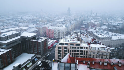 Video - Aerial drone view of Prague city covered in snow with the Old Town square in background. Winter in Czech Republic
