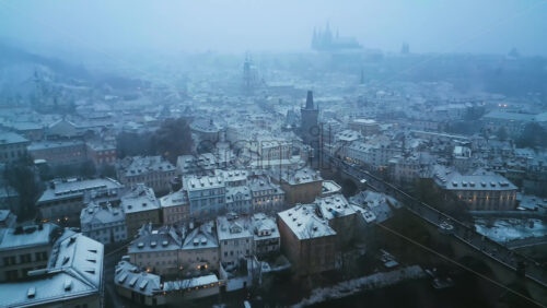 Video - Aerial drone view of the Old Town square covered in snow in the evening. Winter in Prague, Czech Republic