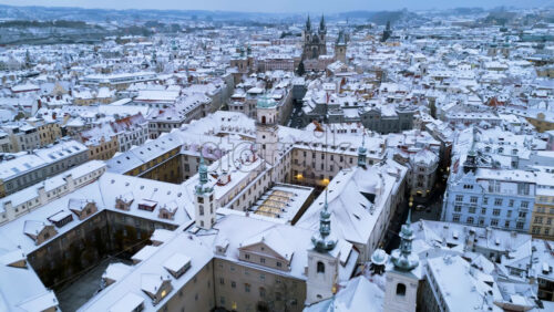 Video - Aerial drone view of Prague city covered in snow with the Old Town square in background. Winter in Czech Republic