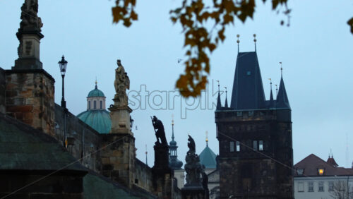 Video - Powder Tower and Baroque statues of saints and religious figures on the medieval Charles bridge in Prague, Czech Republic