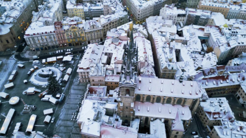 Video - Aerial drone view of ancient gothic Church of Our Lady before Tyn in the Old Town square covered in snow. Winter in Prague, Czech Republic